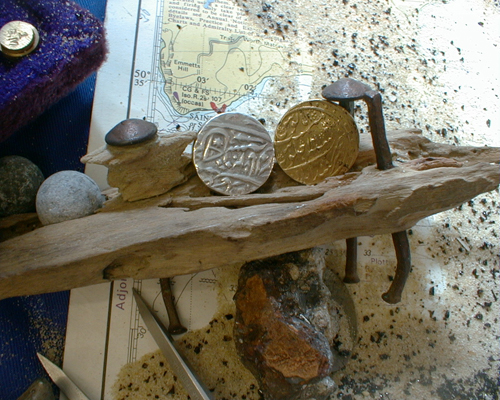 Gold and silver coins from India on display.